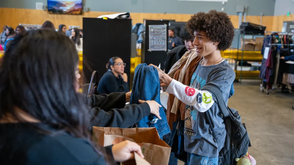 Student receiving pants at the FUF Suit Drive